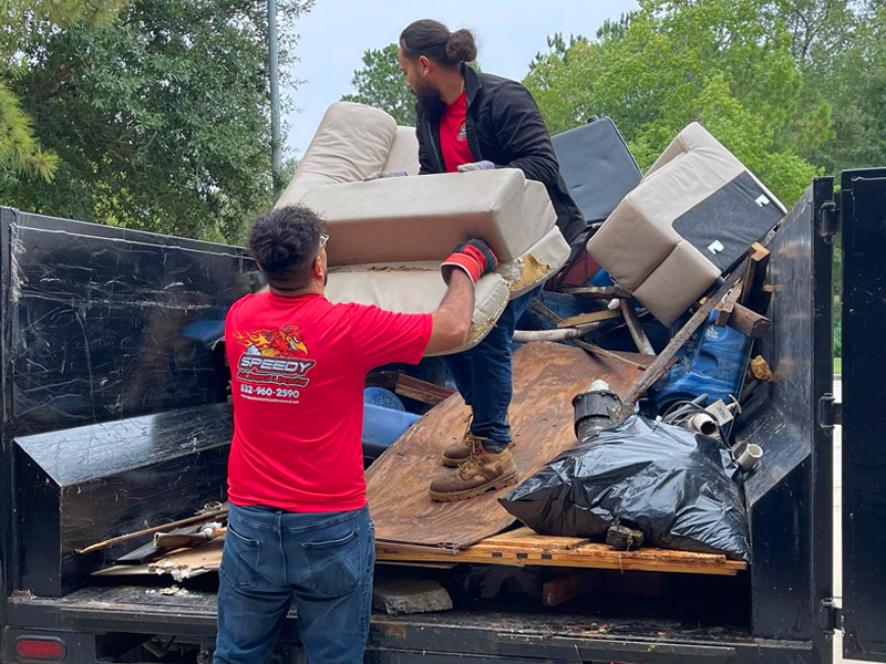 loading furniture and junk into a trailer, residential junk removal, houston tx, speedy junk removal